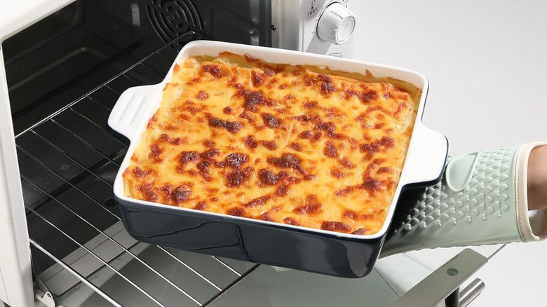 Person pulling a Sweejar baking dish from oven