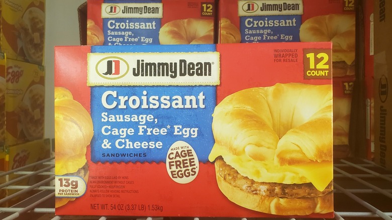 A box of Jimmy Dean Croissant sausage, cage free egg & cheese sandwiches in a freezer at Costco