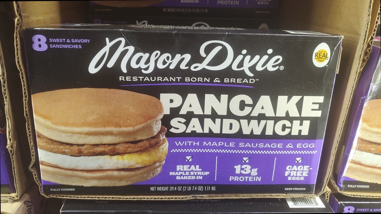 A box of Mason Dixie pancake sandwiches with maple sausage & egg in a freezer at Costco