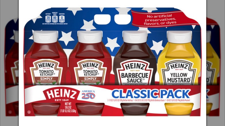 A stars and stripes package of Heinz ketchup, barbecue sauce, and yellow mustard on a white background