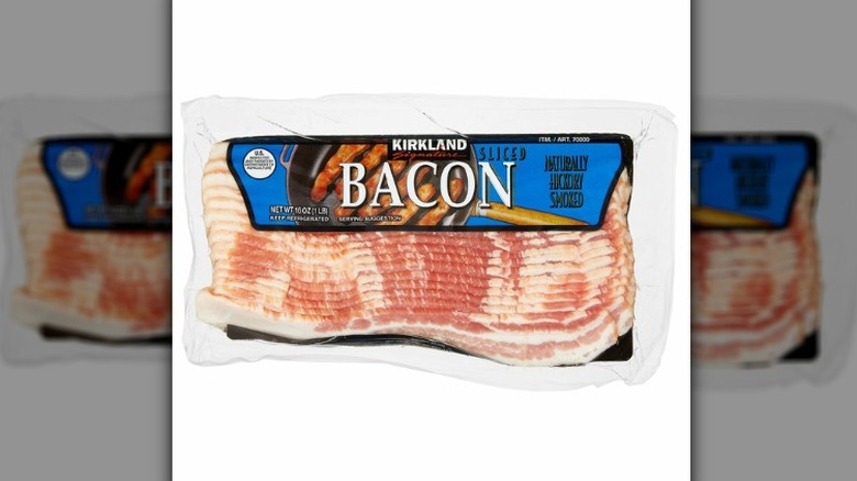 Kirkland Signature sliced hickory-smoked bacon on a white background