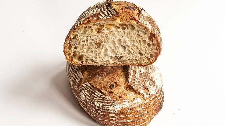 Sliced half loaf of Grand Central Bakery Seattle Potato Sourdough Bread against a white background