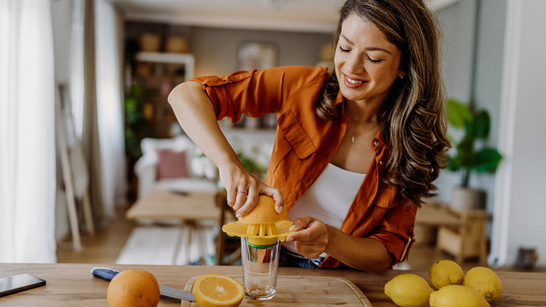 woman making homemade fruit juice