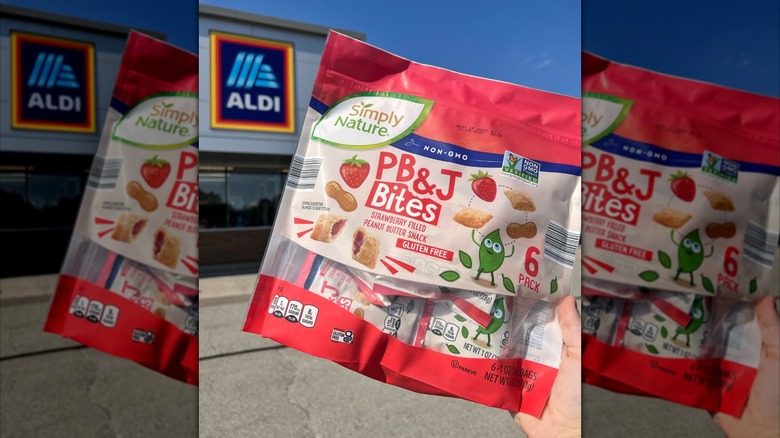 A close-up photo of a pack of Simply Nature PB & J Bites with an Aldi store in the background
