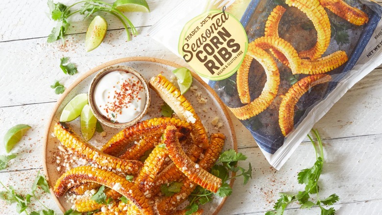 Trader Joe's Seasoned Corn Ribs bag on a table next to a prepared plate