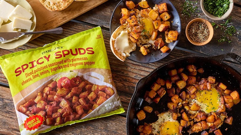 Trader Joe's Spicy Spuds in a cast iron pan and a bowl with the product bag next to them