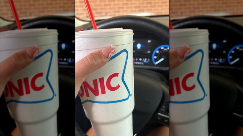 Hand holding cup from Sonic