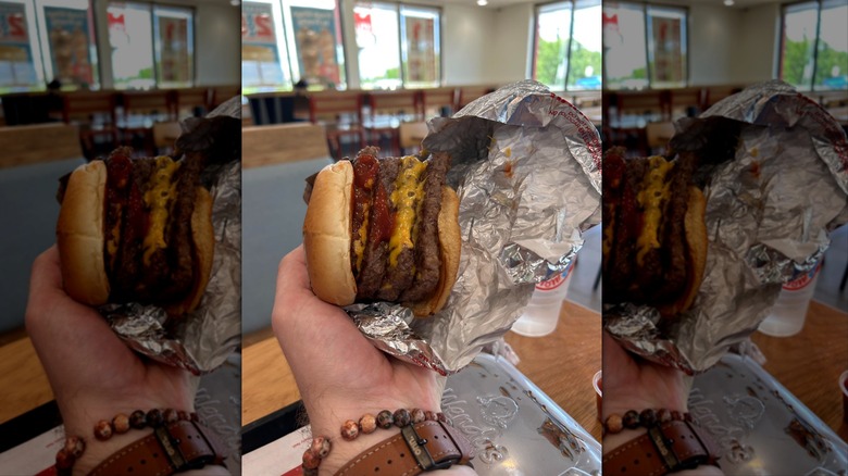 Hand holding Wendy's Meat Cube with wrapper