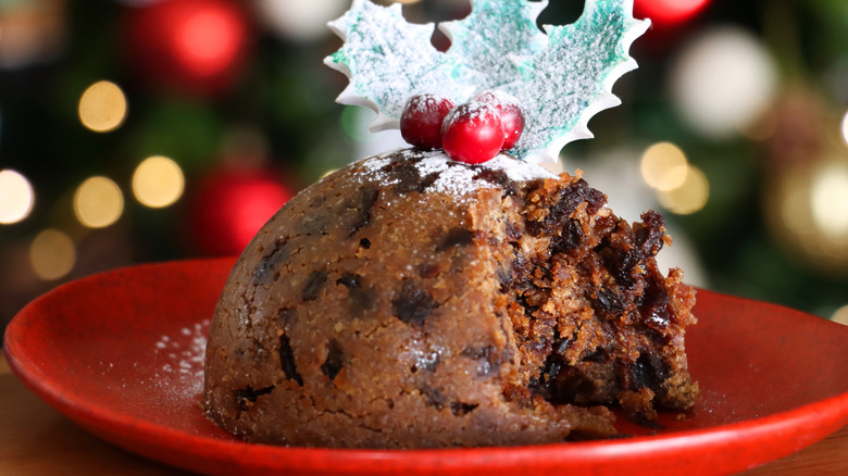 plum pudding with a piece taken out on a plate