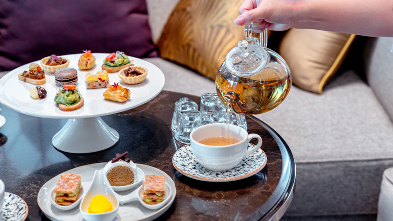 afternoon tea spread on table with ornate dishes