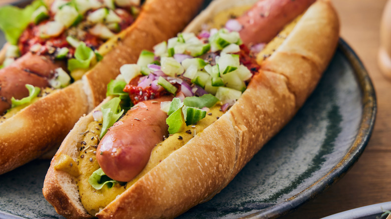 close up of two New York style hot dogs on a plate