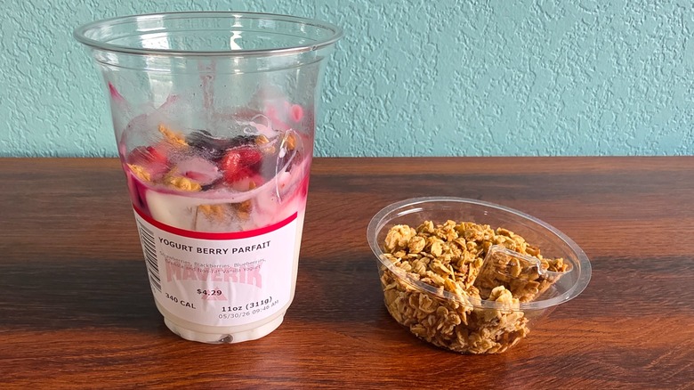 Yogurt berry parfait in cup with cup of granola on side