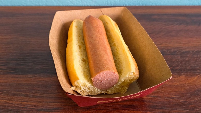Hotdog and bun in paper carton with cut front