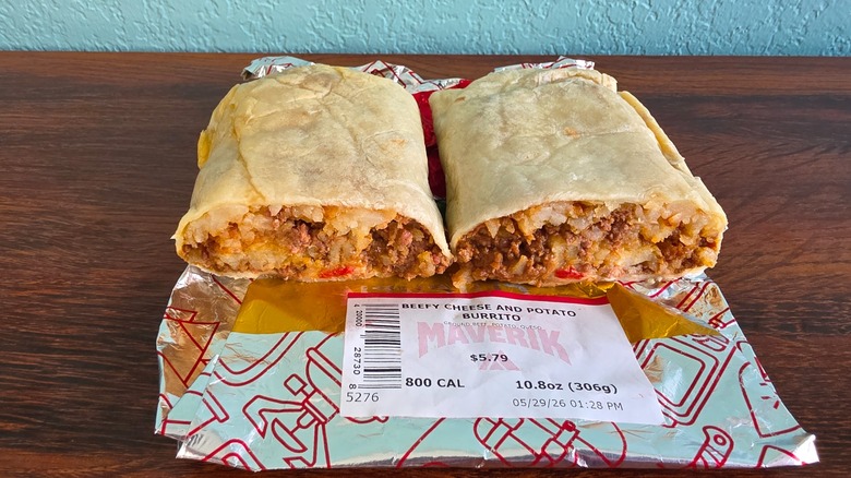 Halved beefy cheese and potato burrito on wrapper