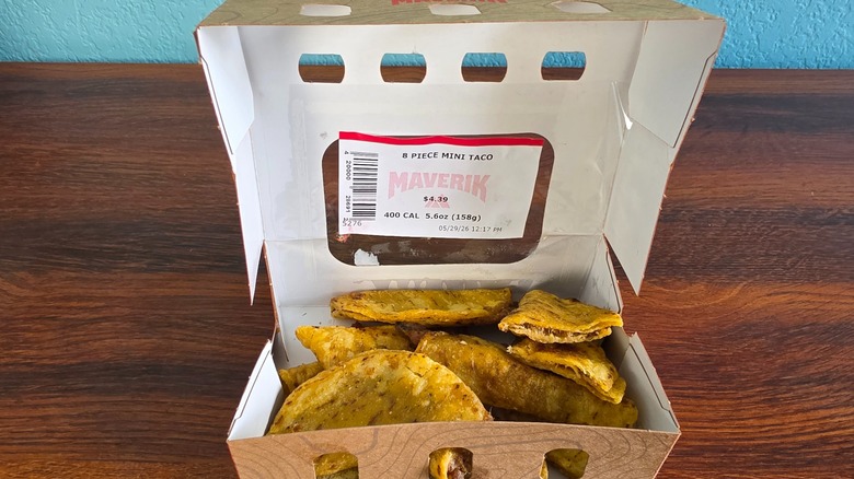 Opened box of 8-piece mini tacos with one cut open