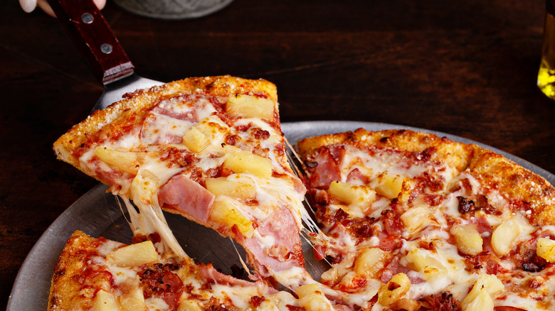 Hawaiian pizza on spatula