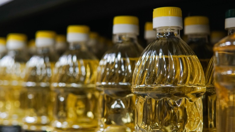 bottles of sunflower oil on supermarket shelf