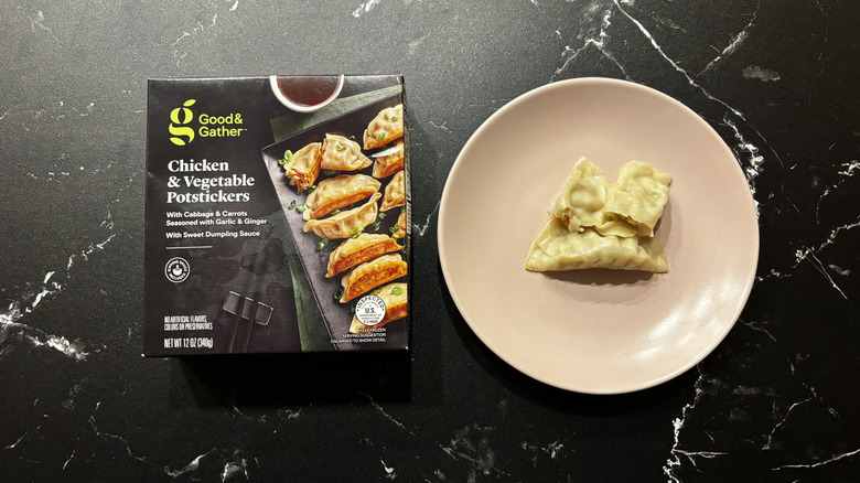 Good & Gather chicken vegetable potstickers box next to potstickers on plate