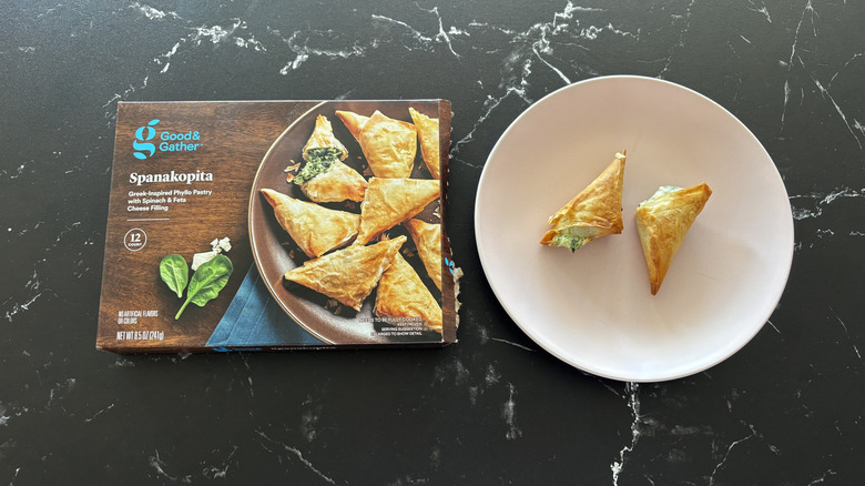 Good & Gather spanakopita box next to spanakopita on plate