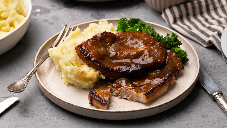 Pork steaks on plate with mashed potatoes and broccoli