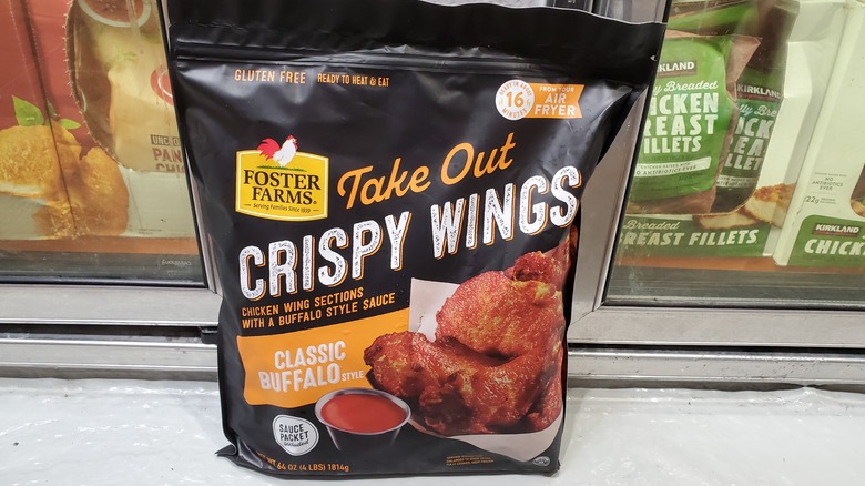A bag of Foster Farms take out crispy wings classic buffalo style in a freezer at Costco