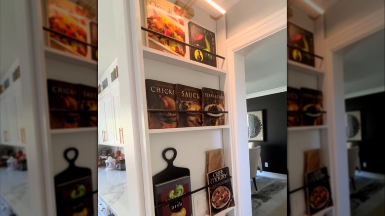 Cookbooks on a full-length wall rack.