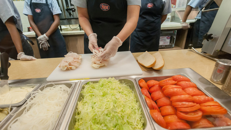Jersey Mike's employees with submarine ingredients in containers