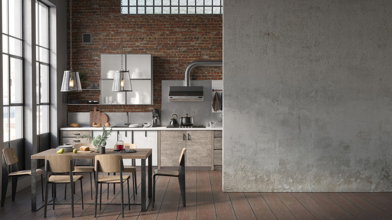 Loft kitchen with exposed brick wall and tall windows