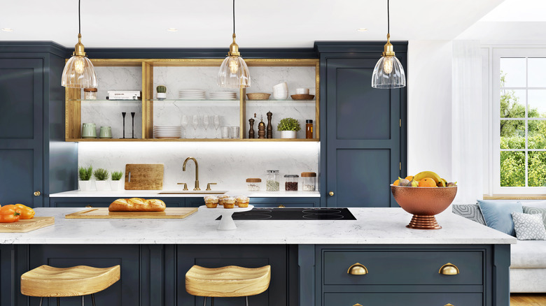 Modern kitchen with navy blue cabinets and brass hardware