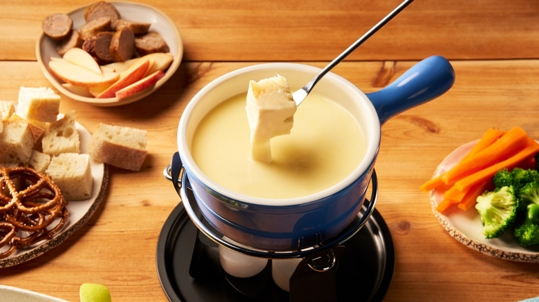 pot of cheese fondue with sides