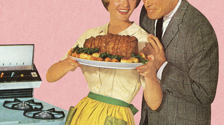 Retro couple holding a roast dinner