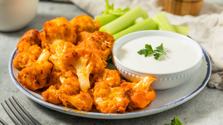 Bowl of cauliflower wings with a dipping sauce