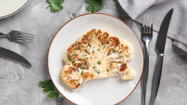 Cauliflower steak on a plate with seasoning
