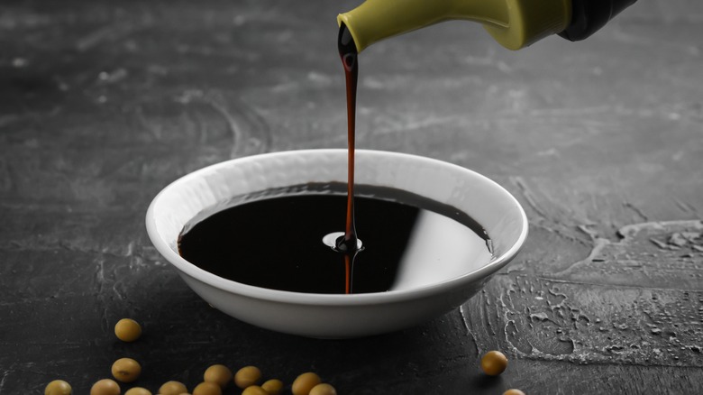 Soy sauce poring in a bowl