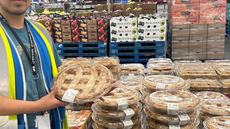 Employee holding Member's Mark Honeycrisp apple lattice pie near display