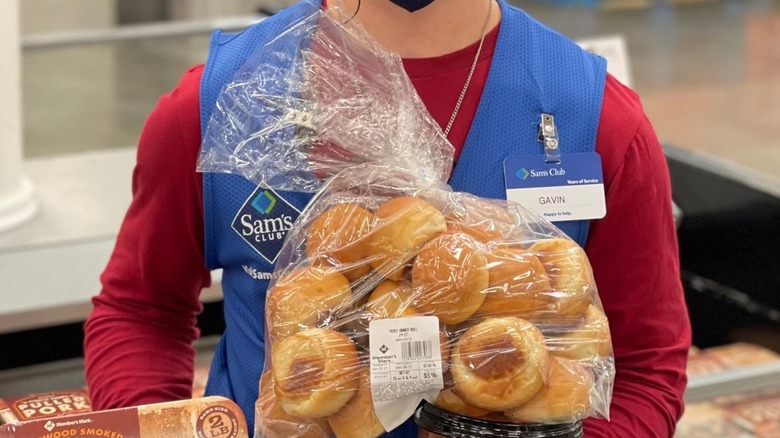 Employee holding a package of yeast dinner rolls