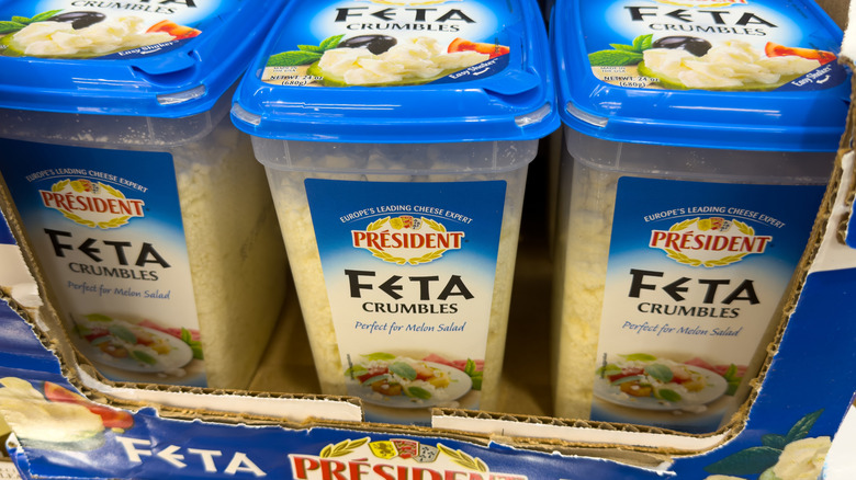 Large containers of President crumbled feta cheese for sale at Costco