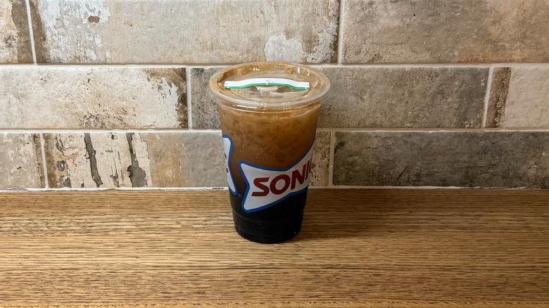 Sonic drink made with Dr. Pepper, sweet cream, cherry, twisted lime, cranberry