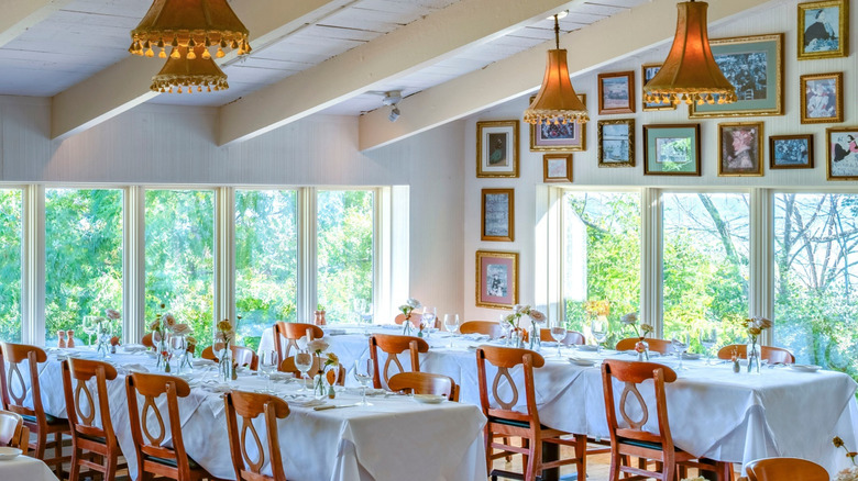 Bartolotta's Lake Park Bistro: interior view of elegant tables, flower decorations, and wall paintings