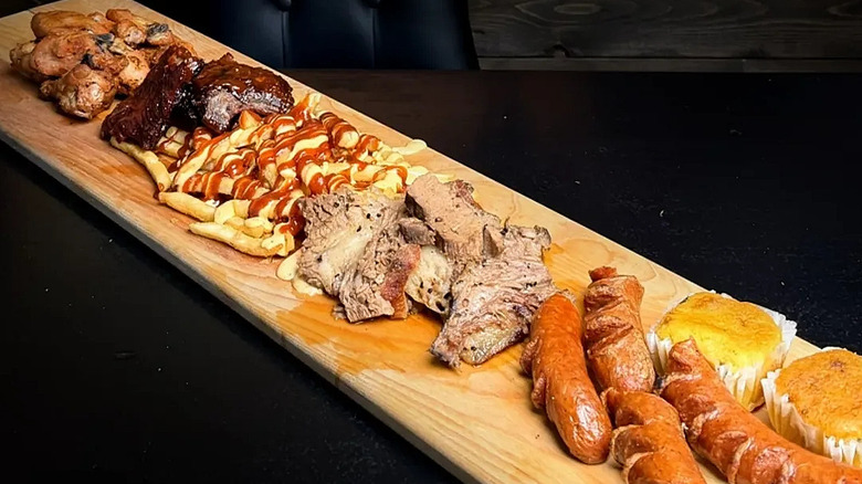Fries, brisket, and sausages on board at Cowboy's Grill
