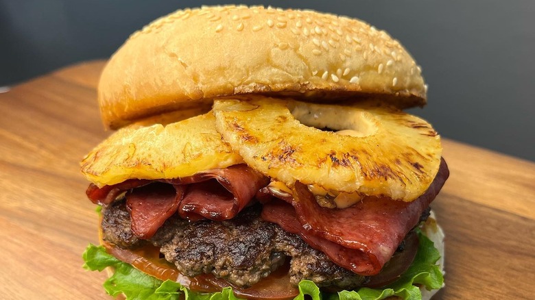 Burger with pineapple and bacon on board at Mountain Burger