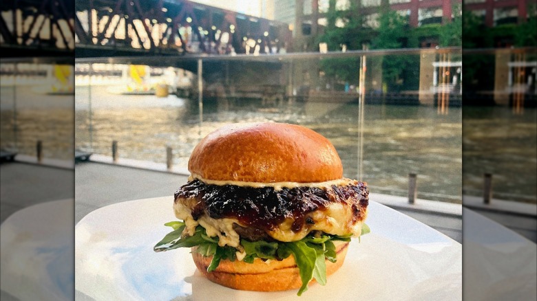 Truffle burger with Chicago River in background at Porter Kitchen and Deck