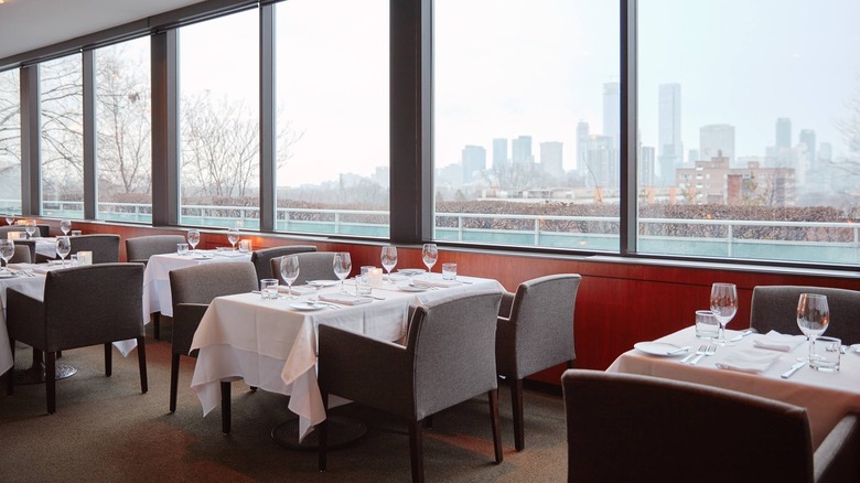 Scaramouche Restaurant's set tables and large windows with lake and skyline views