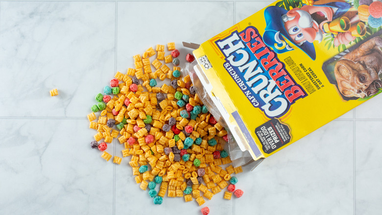 Box of Cap'n Crunch Crunch Berries spilling over marble surface