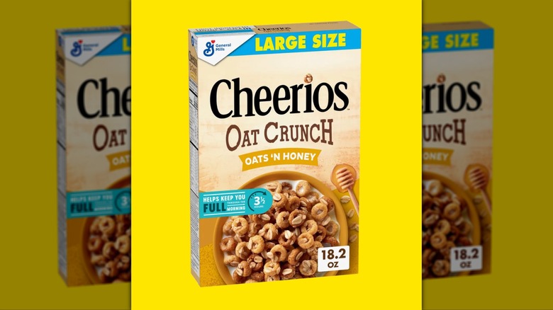Box of Oat Crunch Oats 'N Honey Cheerios on yellow background
