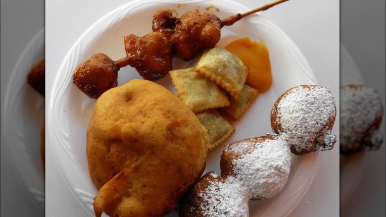 A plate of various deep-fried foods, with parcels of deep-fried beer in the center