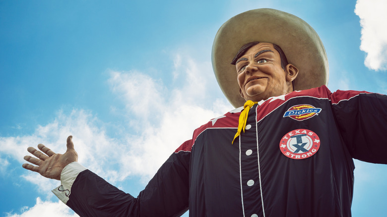 Closeup of the Big Tex statue against blue sky with clouds