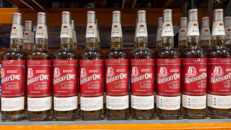 A large selection of Kentucky Owl bottles shown on a liquor shelf
