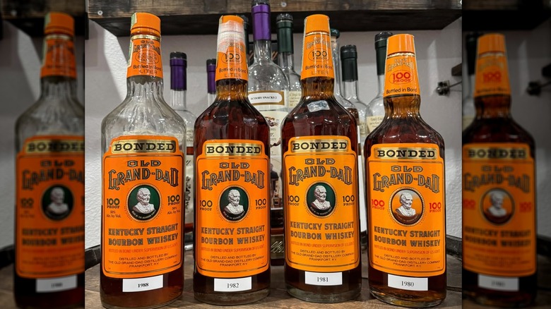 A selection of Old Grand-Dad Bonded bourbon bottles shown from various years