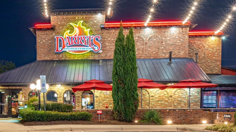 Exterior of Darryl's Wood Fire Grill at night with bright lights